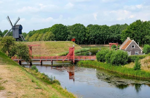 Bourtange Fortress, drawbridge over fortress moat, trestle windmill, Groningen Province,