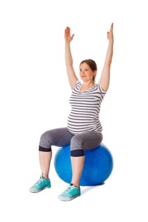 Pregnancy exercise concept, pregnant woman doing exercises with exercise ball isolated on white