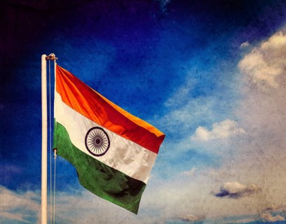 Vintage retro effect filtered hipster style image of India indian flag against blue sky with