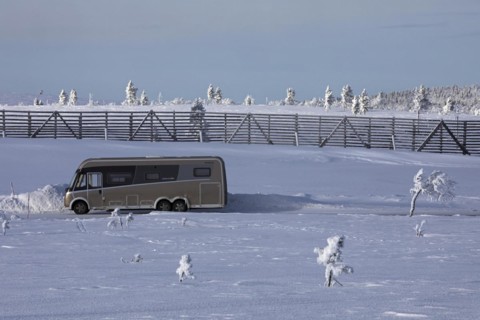 Winter camping with camper van on a mountain near Saariselkä, Lapland, Finland, Europe