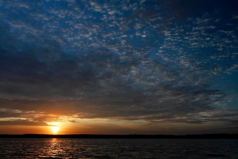 Sunrise with cloud formation over a lake in Mecklenburg, Müritz National Park,
