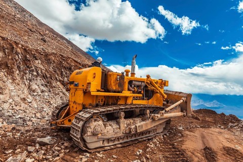LADAKH, INDIA, SEPTEMBER 12, 2011: Bulldozer doing road constractuion on Kardung La pass in