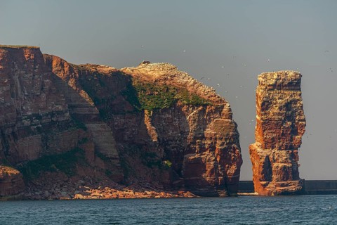 Red red sandstone cliff edge, Heligoland high sea island, Lange Anna, North Sea, blue sky,