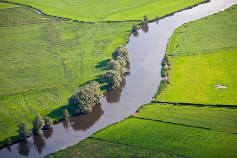 Aerial view over farmland and river bend of the Eider near Rendsburg, Schleswig-Holstein, Germany,