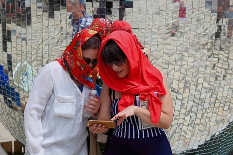 Two girls with red headscarves, sunglasses and mobile phones, Kiev, Ukraine, Europe
