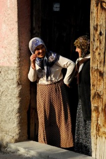 Women in front door, headscarf, Güzelyurt, Cappadocia, Turkey, Asia