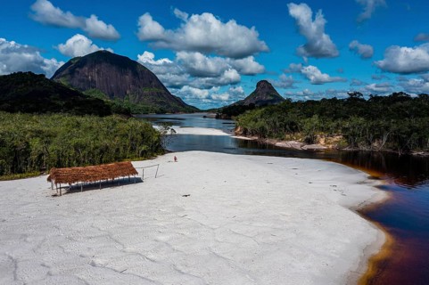 Black river and white sand beach before the granite hills, Cerros de Mavecure, Eastern Colombia