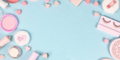 Banner with cute pink makeup beauty products like brushes, powder or lipstick on sides of pastel