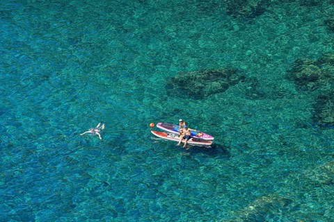 Bathers in the rocky bay of Corniglia, Cinque Terre, province of La Spezia, Liguria, Italy, Europe