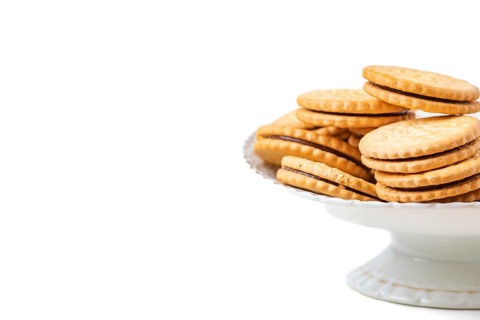 Double biscuits in white bowl, white background, copy space
