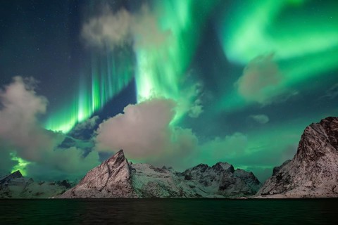 Northern Lights (Aurora Borealis) over mountains in winter, Olstinden, Hamnøy, Reine, Moskenesøy,