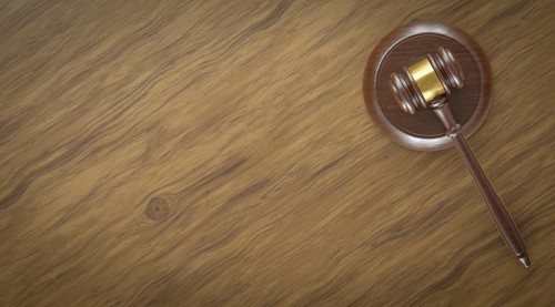 Overhead of gavel resting on a table with room for text