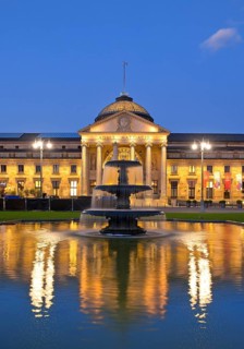 Illuminated spa hotel and Casino in the evening with cascade fountain, Wiesbaden, Hesse, Germany,