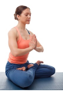 Beautiful sporty fit yogini woman meditates in yoga asana Padmasana, lotus pose with namaste