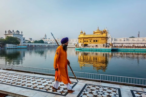 AMRITSAR, INDIA, AUGUST 26, 2011: Sikh guard in Golden Temple Sri Harmandir Sahib Gurdwara in