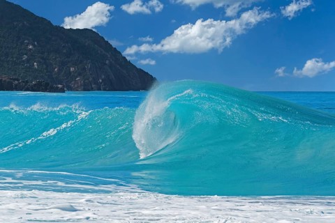 Big wave breaking on the beach at Josiah's Bay, surfing paradise on the island Tortola, British