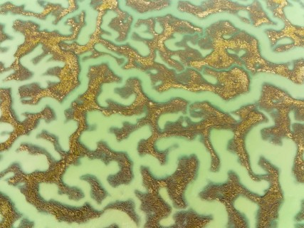 Network of channels and streams at low tide, in the marshland of the Bahía de Cádiz, aerial view,