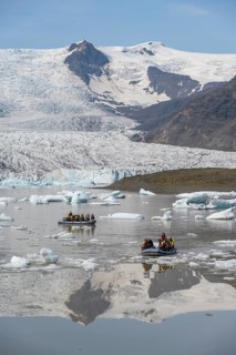 Boats with tourists in the glacier lagoon, ice lagoon Fjallsárlón, ice floes in front of glacier