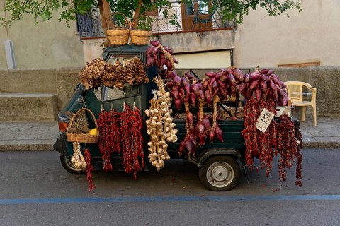 Piaggio tricycle van as a sales stand with onions and herbs, Tropea, Vibo Valentia, Calabria,