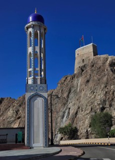 Minaret of the Masjid al-Khor Mosque and Mirani Fort in Muscat, Oman, Asia