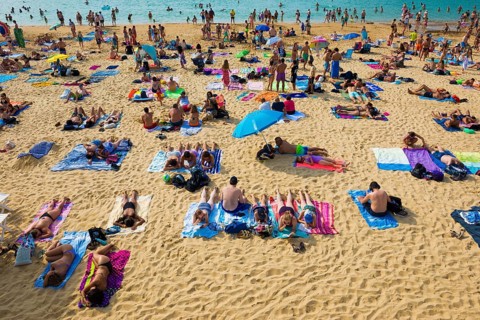 Crowded beach with people in August, San Sebastian, Donostia, Basque Country, Northern Spain,