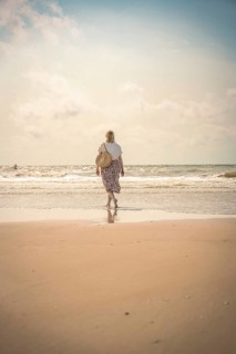 Woman on the beach in the evening sun, Zandvoort, Netherlands