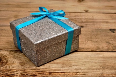 Gift birthday Christmas present concept, silver gift box with blue ribbon on old wooden background