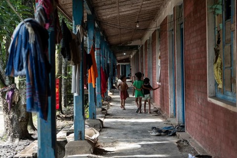 Meitei community man stays in a makeshift shelter after a mob burn their houses during an ethnic