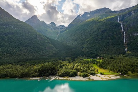 Lake Lovatnet, turquoise lake with mountain flanks and waterfalls, Loen, Stryn, Fe, Norway, Europe