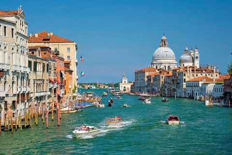 VENICE, ITALY, JULY 19, 2019: View of Venice Grand Canal with boats and Santa Maria della Salute