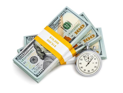 Time is money loan concept background, stopwatch and stack of new 100 US dollars 2013 edition