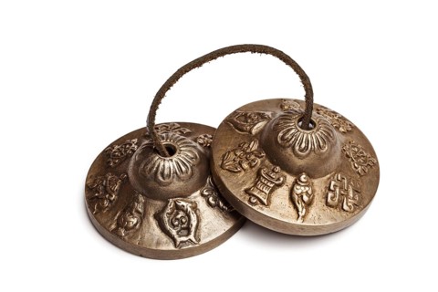Tibetan Buddhist tingsha cymbals isolated on white