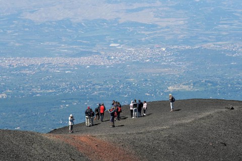 Hikers in the crater landscape of the volcano Etna, summit region, province of Catania, Sicily,