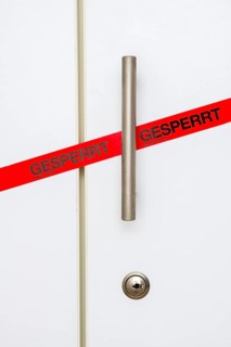 Locked, tape on taped office cupboard door