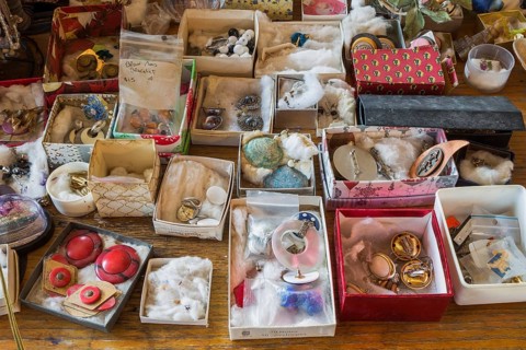 Earrings for sale displayed in boxes on table inside second hand goods and chattels store, Quebec,