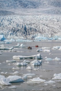 Boats with tourists in the glacier lagoon, ice lagoon Fjallsárlón, ice floes in front of glacier