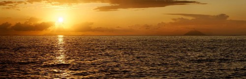 Sunset panorama on the beach of Tropea with the Aeolian (Liparic) Islands and the volcanic island