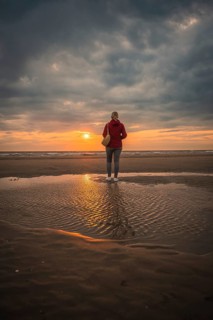 Tourist on the beach at sunset, Zandvoort, Netherlands