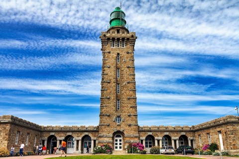 Cap Fréhel lighthouse with tourists, Emerald Coast, Brittany, France, Europe