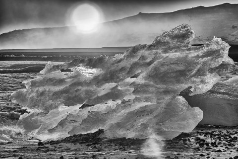 Backlit block of ice, b&w image, beach at glacier lagoon Jökulsarlon, Breiðamerkursandur, south
