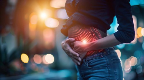 A woman is holding her stomach, stomach pain during menstruation or constipation or other illness,