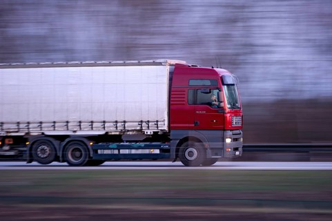 Unconcentrated driver in truck, lorry, semi-trailer MAN TGA 26.440 driving fast on the A92
