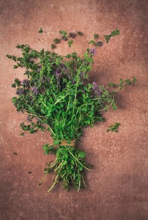 Bouquet of herb ombalo, marsh mint, bunch of mint, top view, on a brown background, spice, Georgian