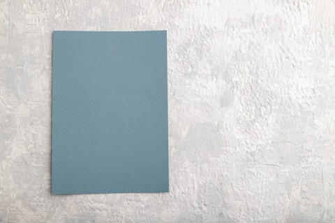 Blue paper business card, mockup on gray concrete background. Blank, flat lay, top view, still