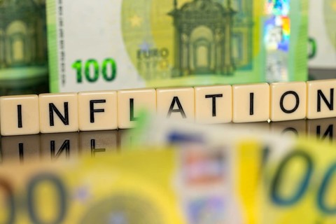 Symbolic image of inflation: euro banknotes and letter cubes showing the word inflation