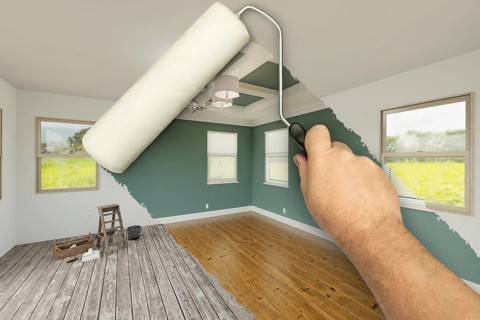 Before and after of man using A paint roller to reveal newly remodeled room with fresh green paint,