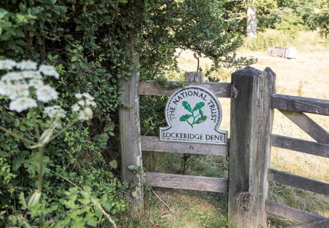 National Trust sign at an entrance to Lockeridge Dene, near Marlborough, Wiltshire, England, UK