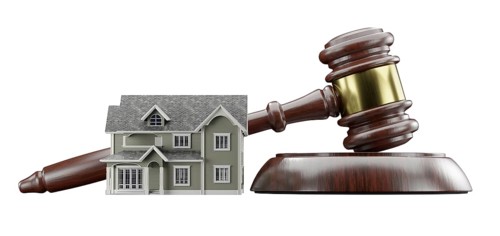 Miniature model house and gavel isolated on a white background