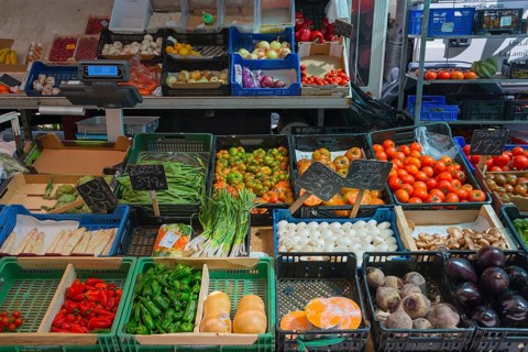 Market stall with a wide selection of fresh vegetables such as tomatoes and aubergines, San