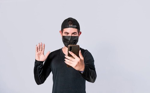 Man making video call isolated, guy making video call with face mask, face mask video call concept